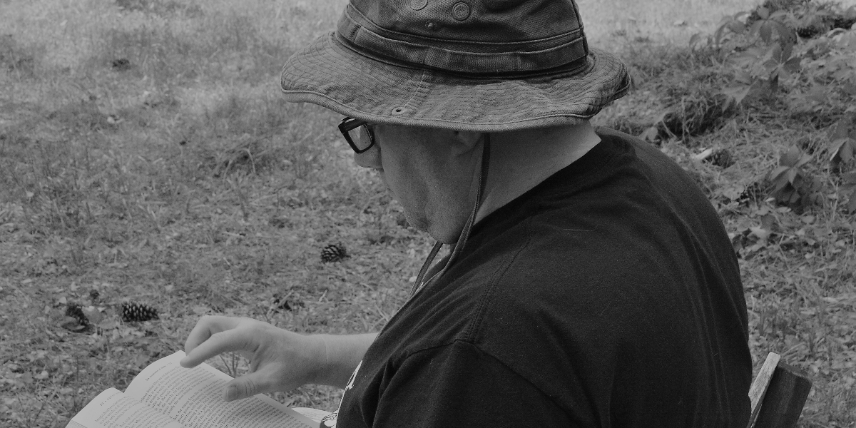 The author reading in his backyard