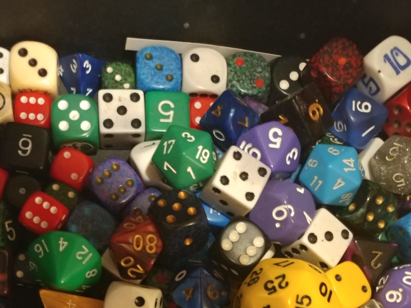 A large and varied pile of dice.