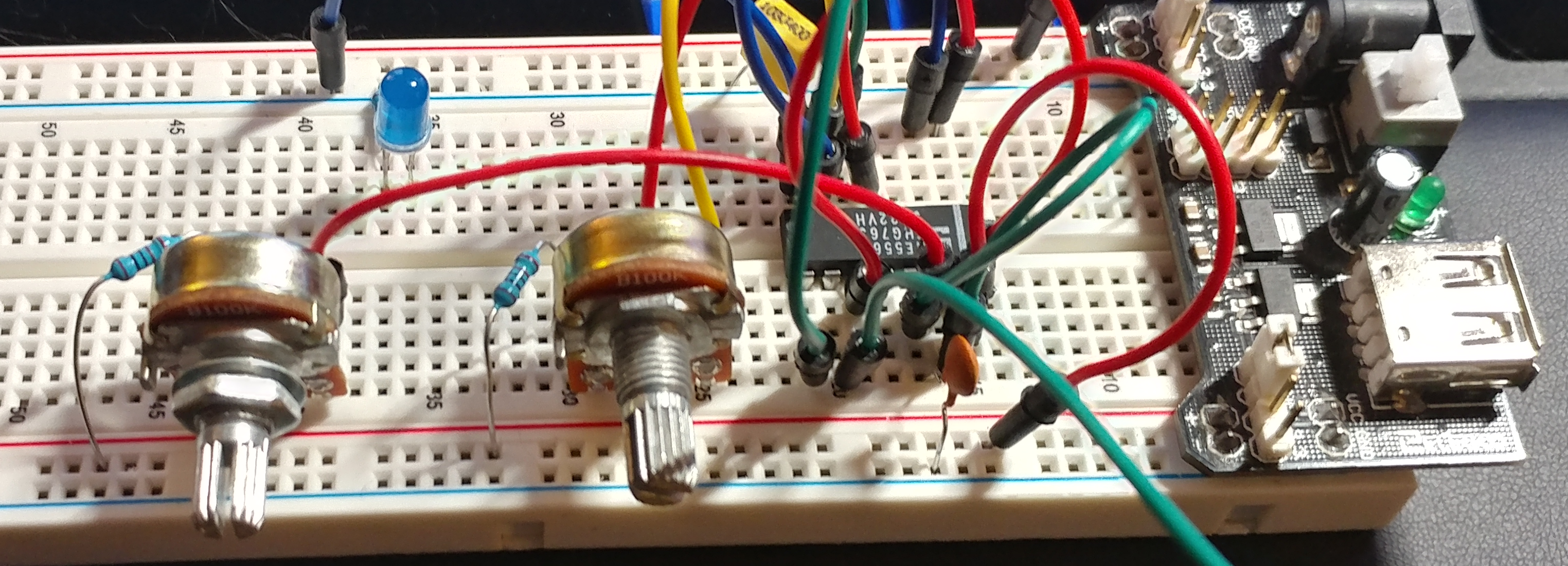Close up of a Atari Punk console on a breadboard with no speaker, but a blue LED.